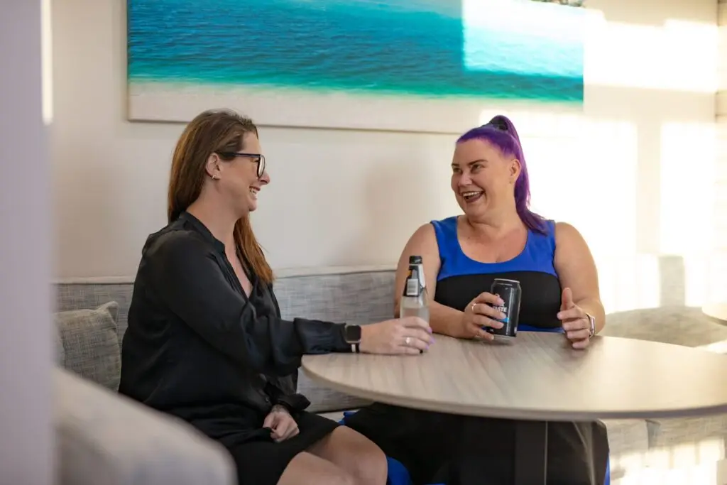 Two women talking and laughing with each other