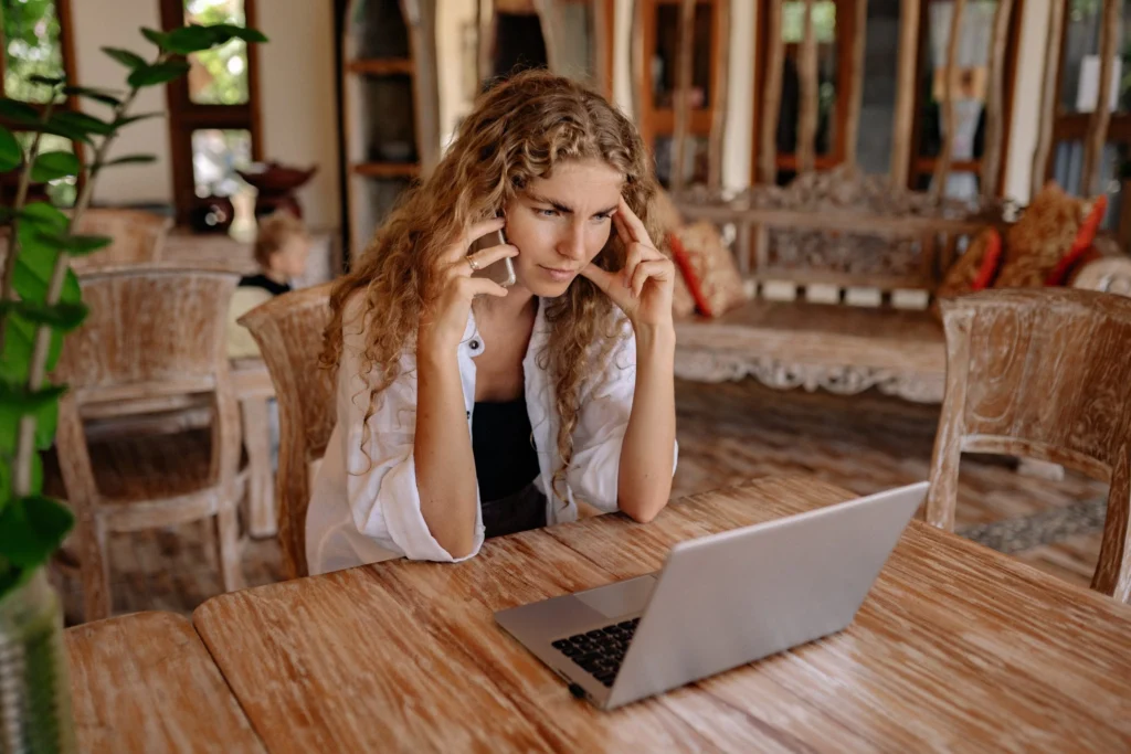 Business owner thinking while looking at the laptop